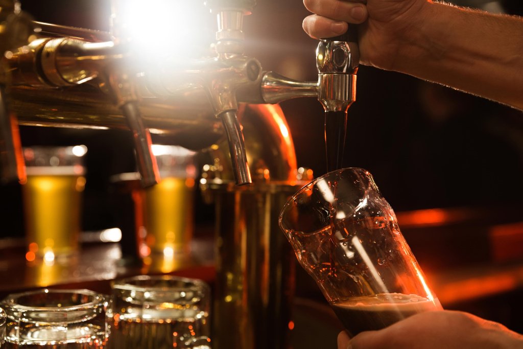 close-up-bartender-pouring-beer-min.jpg